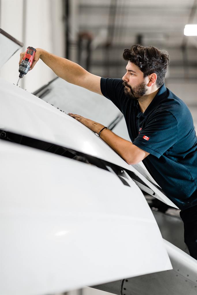 Aircraft Maintenance Engineer inspects a propeller